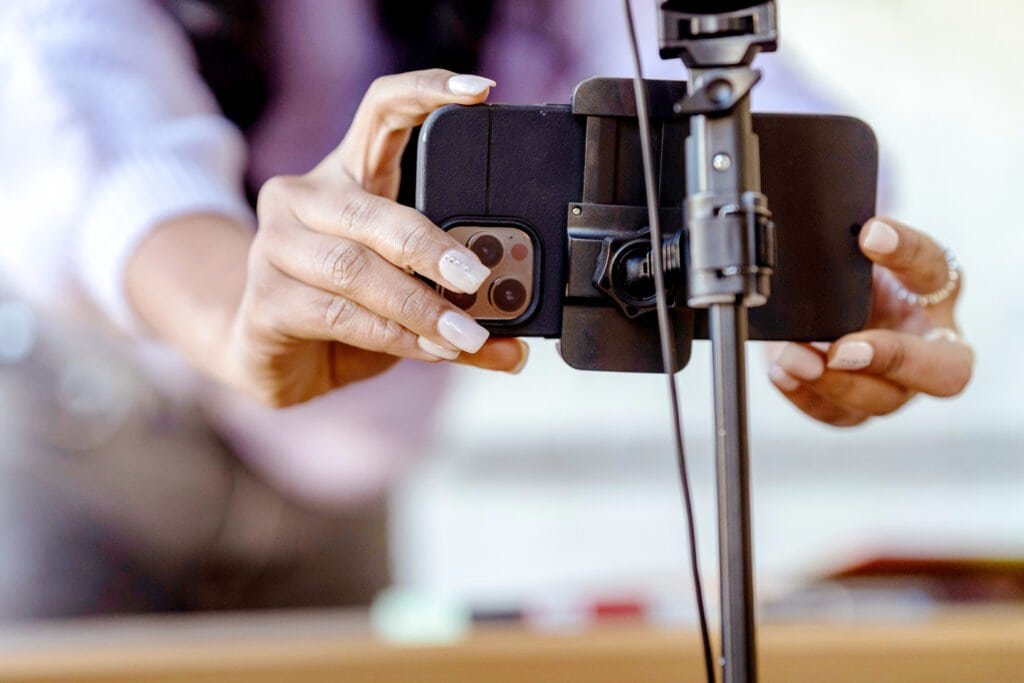 Closeup of Women's hands setting up smartphone on a phone mount